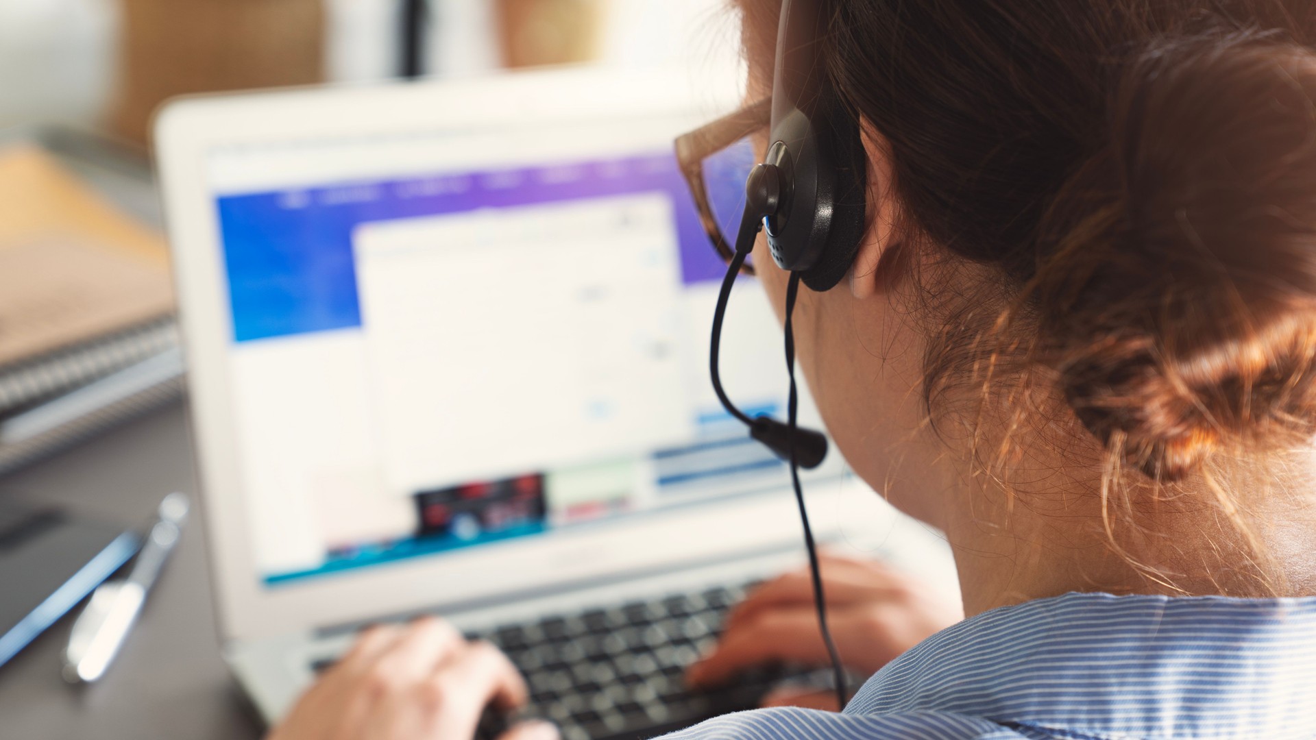 Woman talking on headset in call center